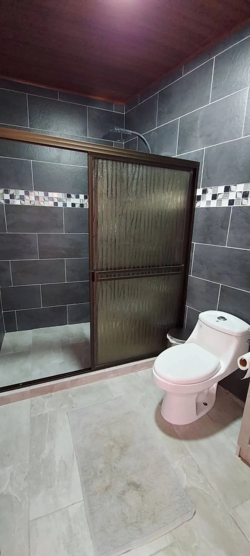 Tiled bathroom with glass shower